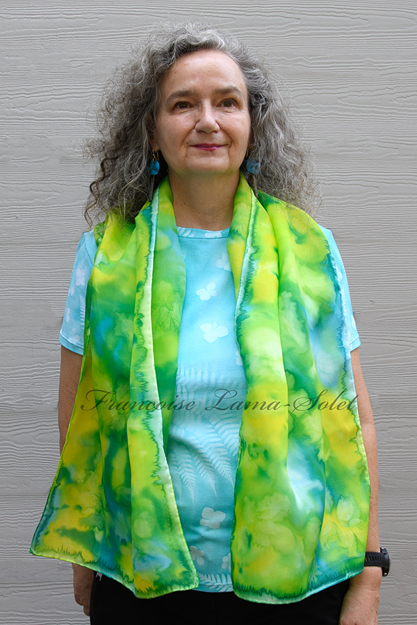 Women's wearable art lightweight silk scarf hand painted in different shades of turquoise, lime green and yellow and sun printed with leaves - Sunny Day
